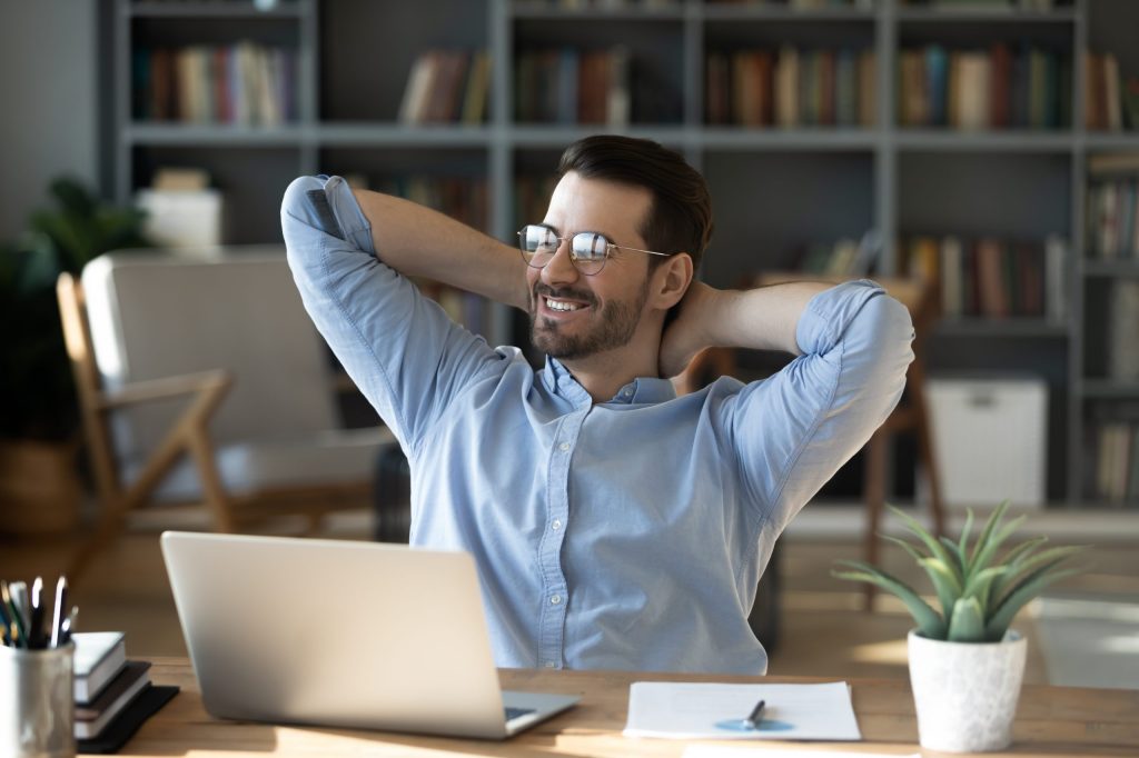Smiling,Businessman,Freelancer,Wearing,Glasses,Leaning,Back,In,Chair,With